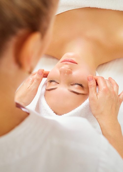 Beautiful woman at a facial massage at a spa salon.